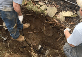 workers in a ditch providing plumbing services - Michael J. Messick Plumbing